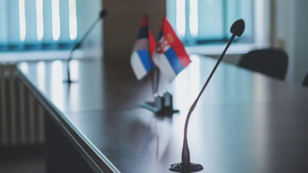 Conference table with microphones and small national flags