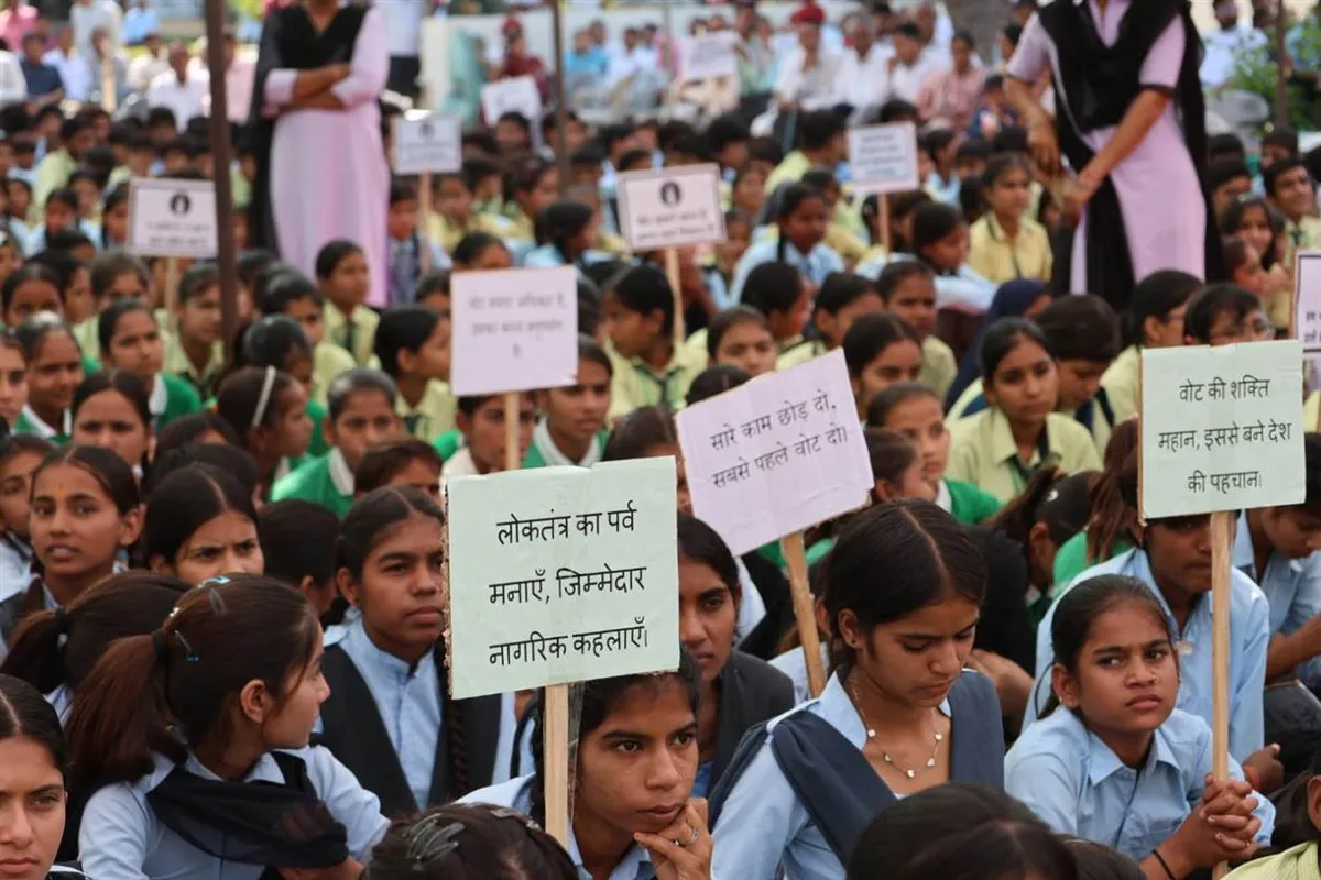 Rajasthan panchayat election: Students hold voter awareness placards at the programme in Nechhwa, Sikar