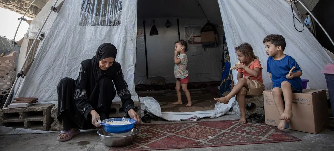 Gaza winter: An elderly woman in Al Saraya, Gaza, looks after young children after losing three sons, her husband and her home in the war
